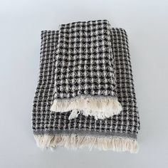 a black and white checkered blanket with tassels