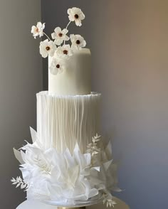 a white wedding cake with flowers on top is displayed in the instagramr screen