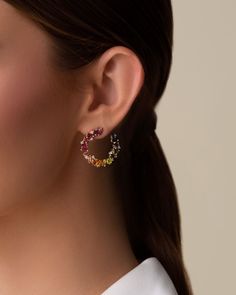 Handcrafted with 14-karat gold, these spiral hoops are meticulously set with vibrant rainbow gemstones and brilliant round diamonds. These gorgeous earrings are an effortless way to make a bold statement for any occasion. Details 14k yellow gold 4x2mm baguette-cut rhodolite, pink topaz, morganite topaz, peridot topaz, green envy topaz and English blue topaz 3x3mm princess-cut rhodolite, pink topaz, morganite topaz, peridot topaz, citrine and English blue topaz 4x4mm clover-cut peridot topaz, cit Rainbow Sapphires, Rainbow Gemstones, Red Ombre, Pink Topaz, Lemon Quartz, Green Amethyst, Stunning Earrings, Baguette Cut, Topaz Gemstone