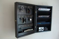 a wall mounted display case with key hooks