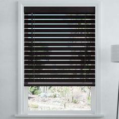 the blinds in this room are made out of wood and have black slats on them