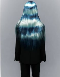 the back of a woman's head with long hair in blue and white streaks