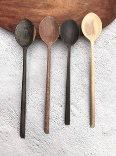 five wooden spoons lined up in a row