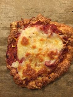 an uncooked pizza sitting on top of a wooden table