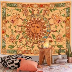 a sun tapestry hanging on the wall above a bed