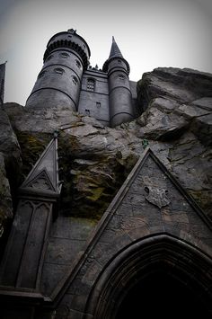 the castle is built on top of a large rock formation, and it looks like it's going to fall down