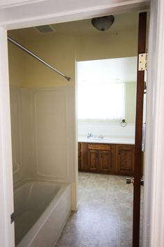 an empty bathroom with a tub and sink