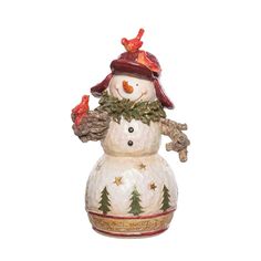 a ceramic snowman ornament with trees on it