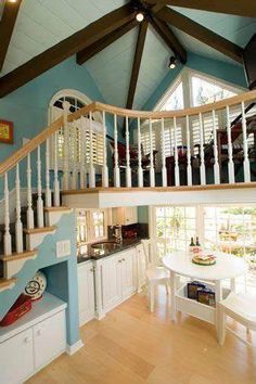 a kitchen and dining area with stairs leading up to the second floor that has an open staircase