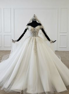 a white wedding dress on display in a room