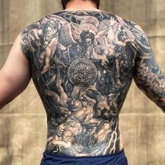 the back of a man with tattoos on his body