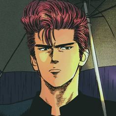 a man with red hair and blue eyes is holding an umbrella in front of him