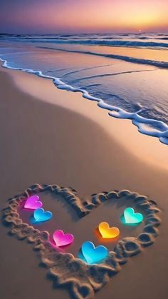 a heart shape drawn in the sand at the beach