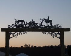 the silhouettes of people and animals are on top of a wooden structure with trees