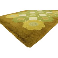 a brown and green rug with flowers on it