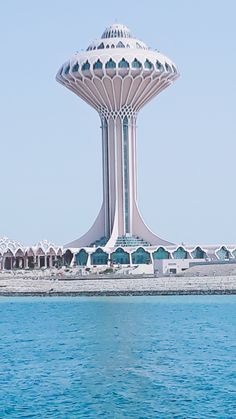 a large white building sitting on top of a body of water