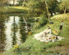 two women sitting on the bank of a river