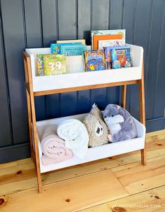 a shelf with books and stuffed animals on it