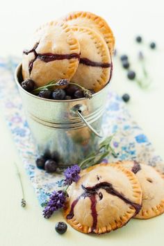 blueberry hand pies in a tin with lavender sprigs