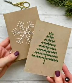 two handmade christmas cards with snowflakes on them, one is brown and the other is green