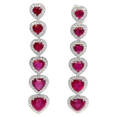 This 18K white gold elegant drop earrings are from our Timeless collection. These stud earrings are made of natural white diamonds in total of 0.60 Carat and natural heart red sapphires in total of 6.55 Carat. Total metal weight is 9 gr. They are 4.5 cm long. The Timeless Collection was inspired by the endless elegance and sophistication of classic high-jewelry, eternising it’s beauty and presenting a selection of classy designs. The intense colours stones give the collections authenticity making it memorable and distinguished from traditional timeless pieces, but it yet keeps the shapes and silhouettes of an art unchanged by time. The precious materials used on the craftsmanship of this collection guarantee that those pieces will last a life-time, making it the perfect present to be passe Ruby Drop Earrings, Diamond Red, Alexis Bittar Jewelry, Ruby Heart, Red Sapphire, Earrings Large, Red Ruby, Large Earrings, High Jewelry