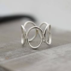 Sterling Silver Open Circle Ring Band - Bubble Ring - Midi Ring This simple sterling circle ring is a great addition to your wardrobe. It is a nice simple modern looking silver ring and so comfortable to wear. I start by making circles and then solder them together and form it into a ring, I then tumble it for hours to a beautiful shine. Each ring will be made to order in your size, please allow 5-7 business days for your ring to be made. Open Circle Ring, Modern Silver Jewelry, Silver Ring Band, Bubble Ring, Handmade Sterling Silver Rings, Jewelry Sale, Midi Ring, Circle Ring, Popular Jewelry