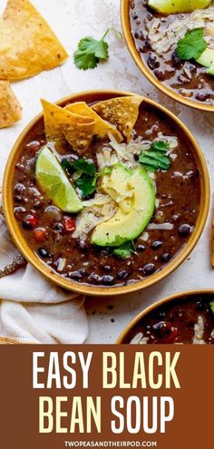 three bowls of black bean soup with tortilla chips and avocado on the side