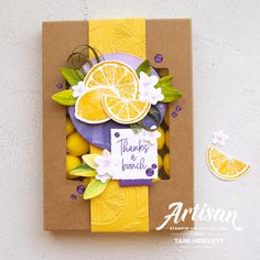 a card made with oranges and lemons on top of a brown paper bag