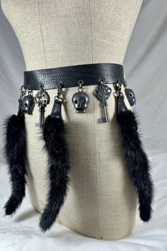 "You are looking at a genuine  black belt by Ronald Pine.  Belt measures 38\"6 long, 1\"4 wide, measuring 31\"5 in the first perforation and 35\"4 at the last perforation from buckle. Belt comes with aged dark silver tone hardware, skulls and keys along with lovely fur. This lovely belt has great craftsmanship with three lovely detachable fur tags. The leather is thick and strong and belt was well cared for. Made in France.  -----------------------------------------I SHIP WORLDWIDE-------------- Fur Belt, Skull Belt, Black Steampunk Belt, Black Adjustable Gothic Belt, Gothic Metal Chain Belt, Goth Belt Chain, Goth Belt Buckle, Animal Tails, Fur Accessories