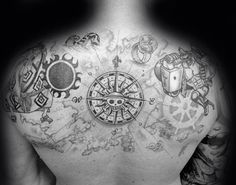 a man's back with tattoos on his chest and some other things in the background