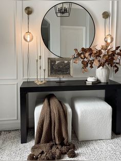 a black table topped with a mirror next to a white bench