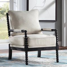 a living room with a chair, rug and window in front of the wall that has a drawing on it