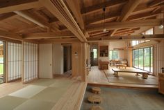 an empty room with wooden walls and flooring in front of large sliding glass doors