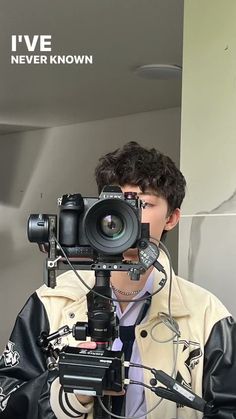 a man holding a camera up to his face