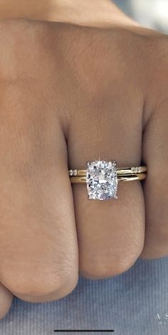 a woman's hand with a ring on it and a diamond in the middle