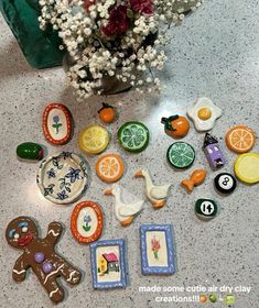 there are many decorated cookies on the table next to a vase with flowers in it