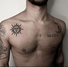 a shirtless man with sun and moon tattoos on his upper half, standing in front of a white wall