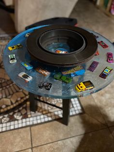 there is a glass table with cars on it