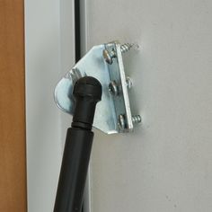 a close up of a door handle with a bolt in the middle and a screw sticking out of it