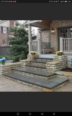 an outdoor patio with stone steps and planters