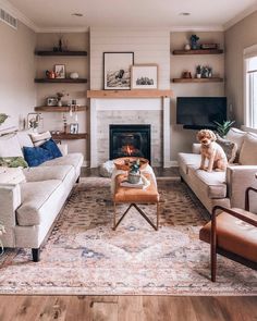 a living room filled with furniture and a fire place in the middle of the room