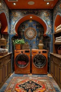 a washer and dryer are in the middle of a room with blue walls