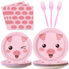 a set of pink plates with pig faces on them and forks in front of it