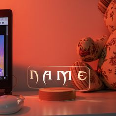 an electronic device sitting on top of a table next to a mouse and a teddy bear