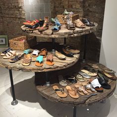 three tiered wooden display with shoes on it