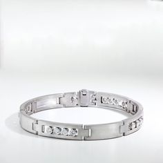 Men's bracelet made in 18K white gold with long smooth rectangular links that are satin finished. Every other station features four round bezel set sliding diamonds. 8" in length. Men White Gold Bracelet, Modern Bracelet, Mens Diamond Bracelet, Diamond Bracelet Design, Modern Bracelets, White Gold Bracelet, Bracelet Design, Men's Bracelet, Mens Jewelry Bracelet