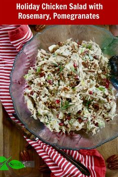 chicken salad with rosemary, pomegranates in a glass bowl on a wooden table