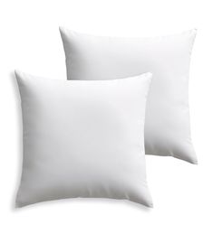 two white pillows sitting next to each other