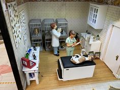 two dolls in a doll house with furniture