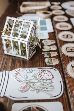 a wooden table topped with lots of cut outs and paper plates on top of it